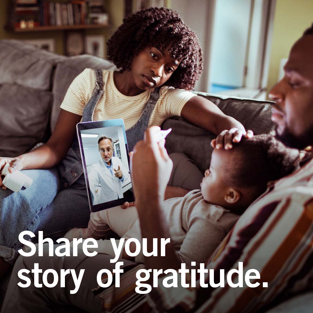 father with two children during telehealth visit with doctor