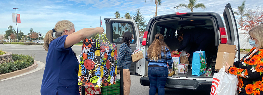 volunteer removing donation items from van