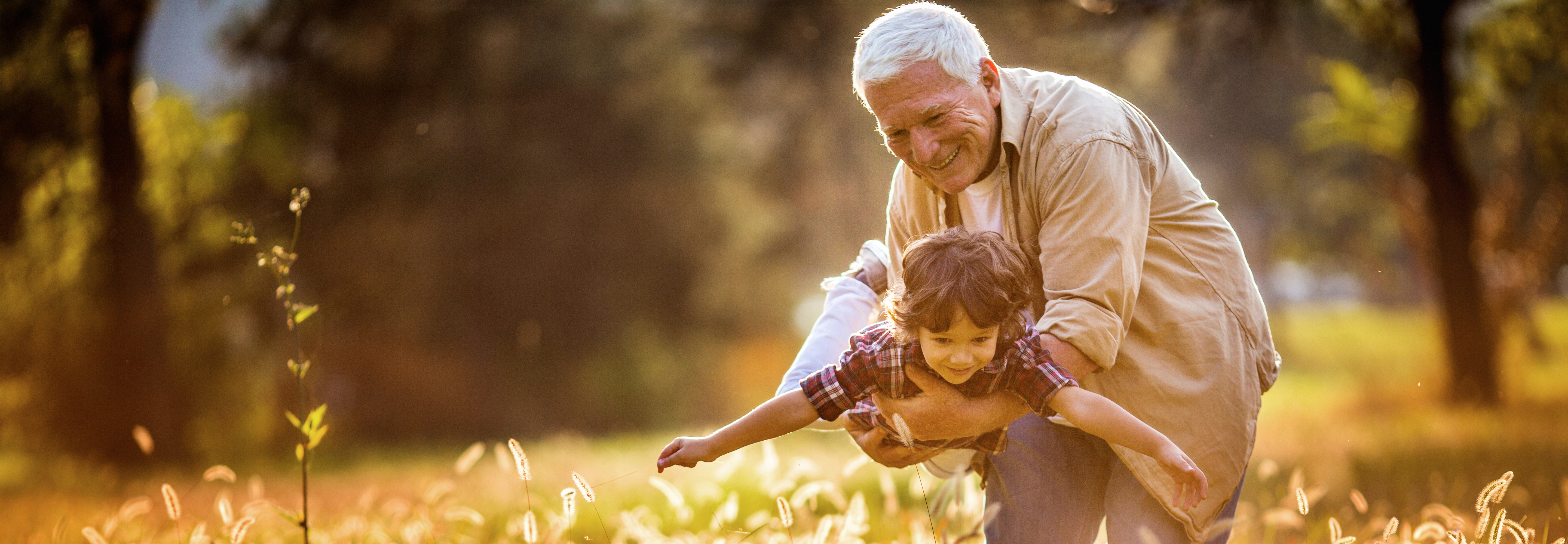 Grandfather playing "airplane" with grandson